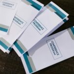 Colorful printed pamphlets showcasing business promotions and graphic design samples by RINZNA SERVICES