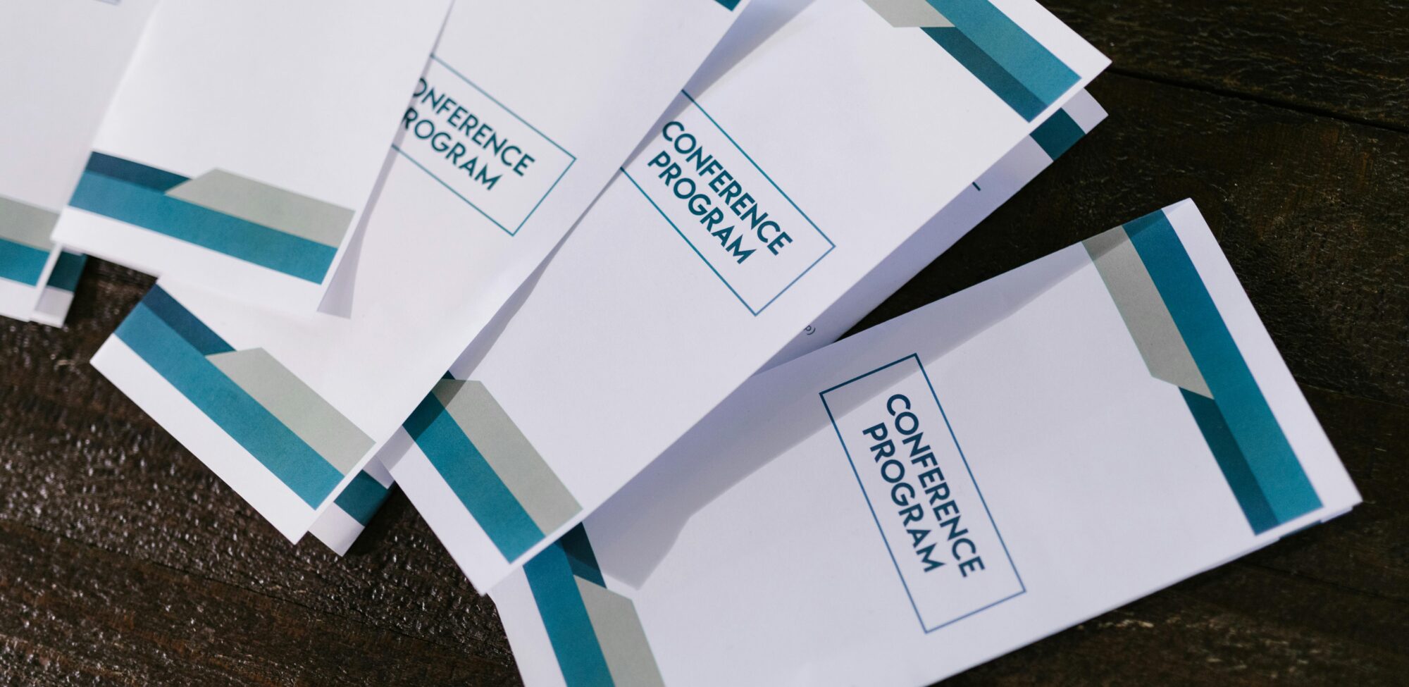 Colorful printed pamphlets showcasing business promotions and graphic design samples by RINZNA SERVICES